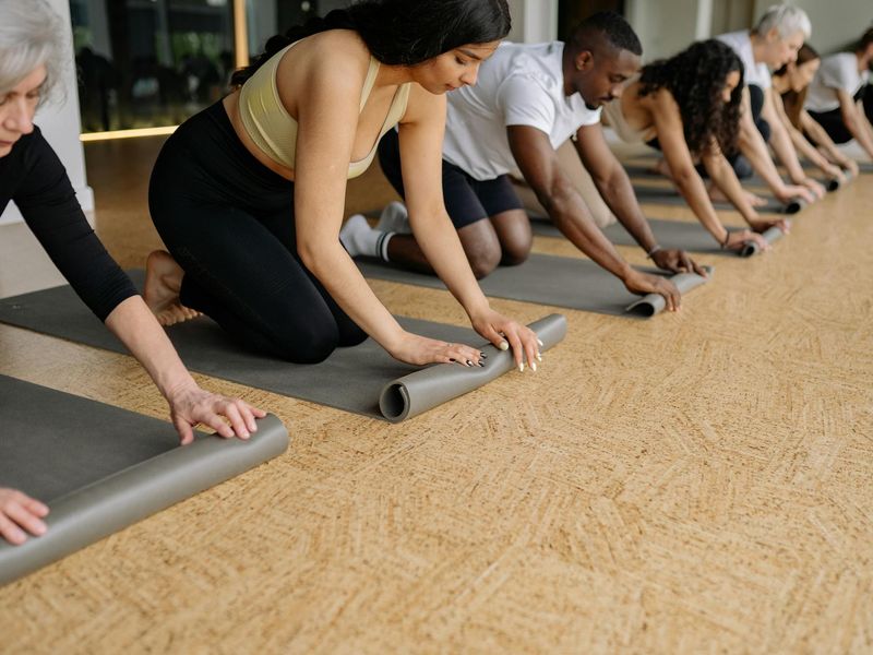 Detailed view of yoga equipment on a dark wooden floor.
